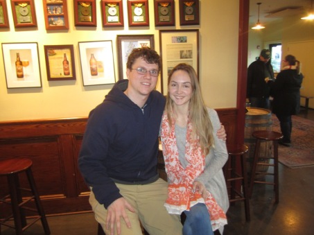 a couple smiling for the camera in the beer hall