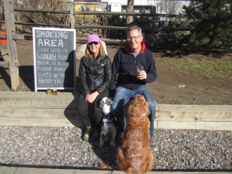 couple with their dogs in the beer garden