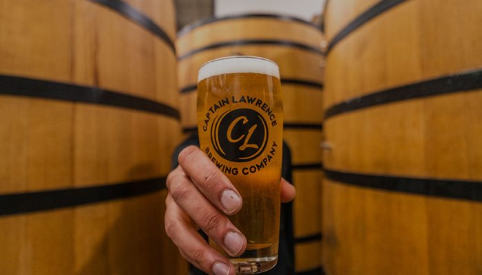 holding up glass of captain lawrence beer