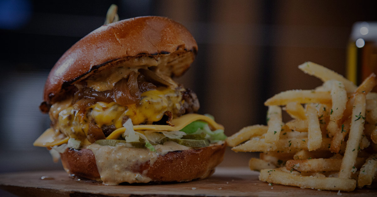 fries and a cheese burger with caramelized onions