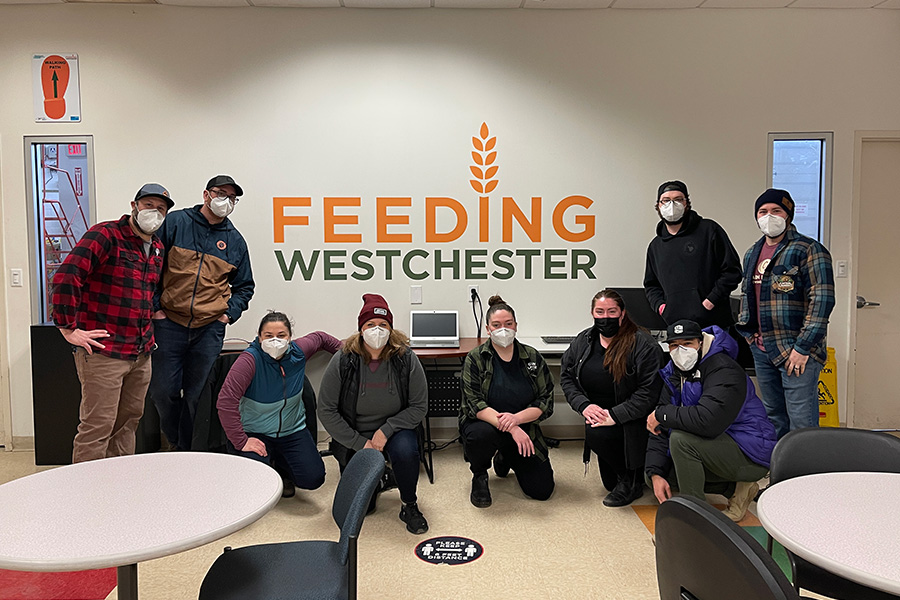 group photo under Feeding Westchester sign